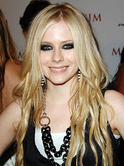 Avril Lavigne skateboards in her garage