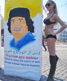 Women whip off shirts in Gaddafi`s support