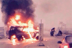 Riot police from a burning car were rescued by witnesses